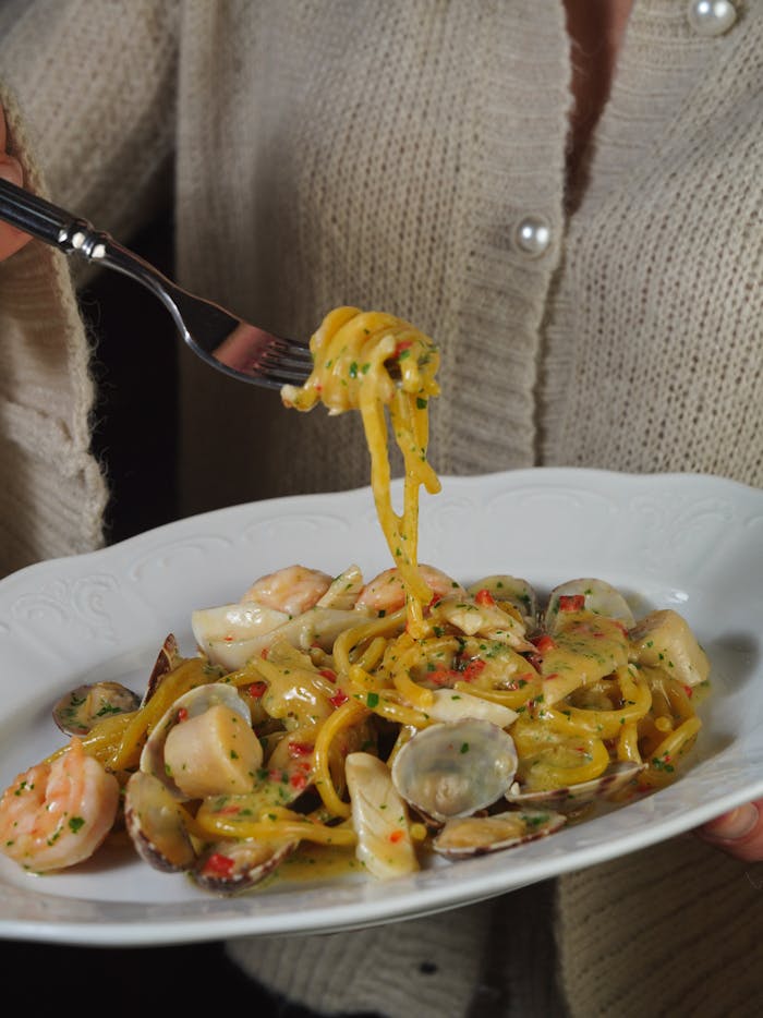 about-us Delicious seafood pasta with clams and shrimp, perfect for a gourmet dinner.